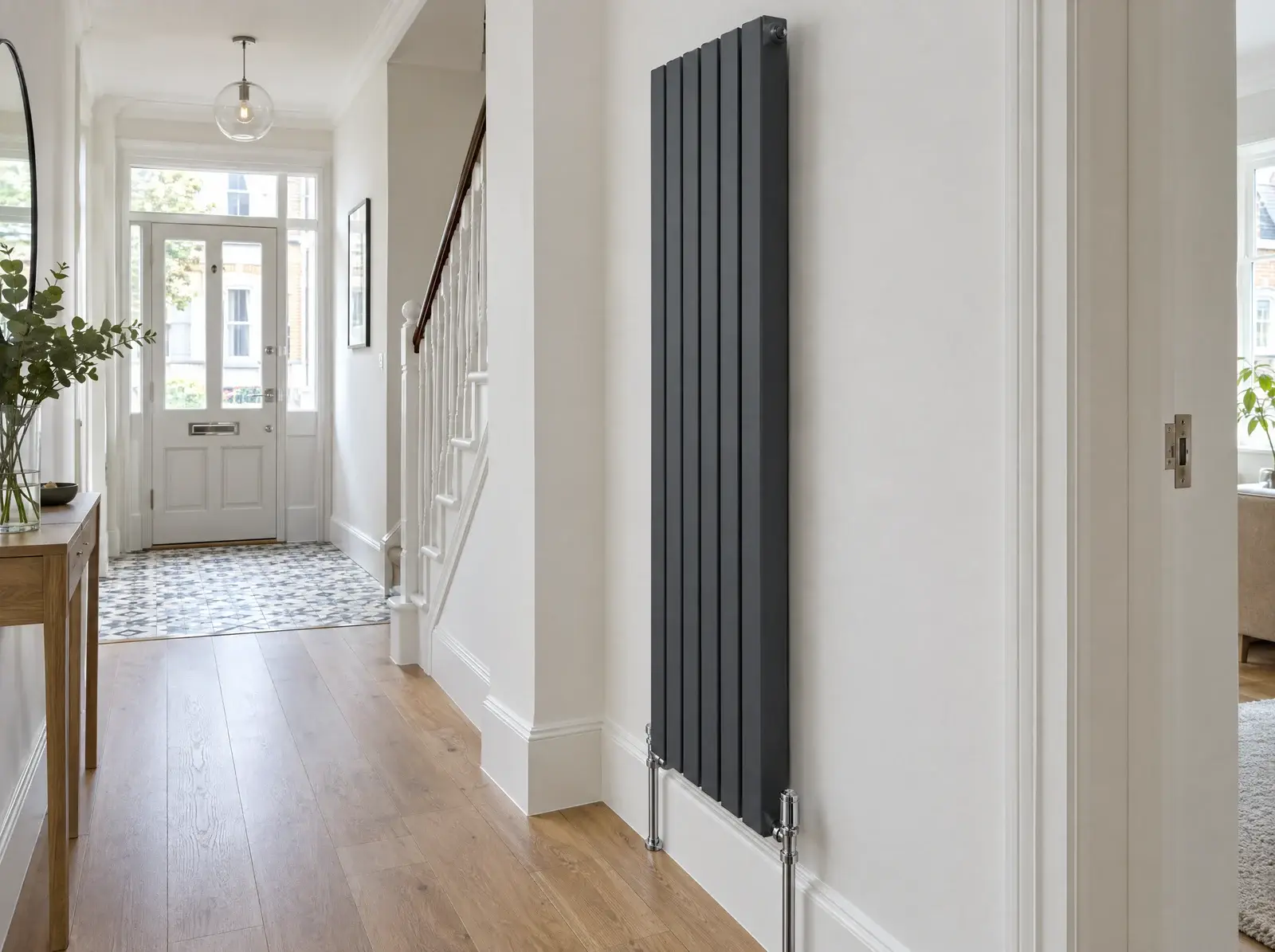 Tall anthracite designer radiator in a bright hallway